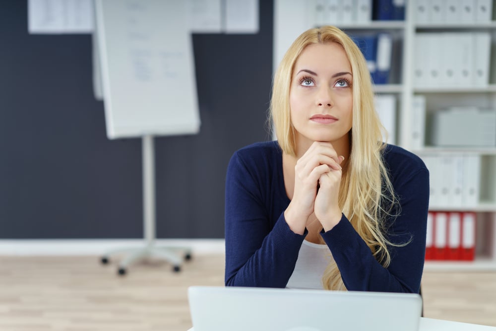 woman stares into space in an office setting